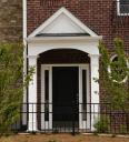 This roof and arch adds curb appeal to an otherwise plain front door