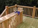 Cedar rail with an extended top cap acting as a shelf for entertaining