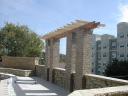 This Cedar Arbor sets atop the stone columns around the pool area